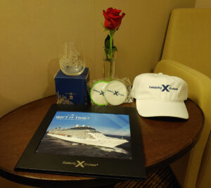 Ballcap, glass, rose, coasters from celebrity cruise line